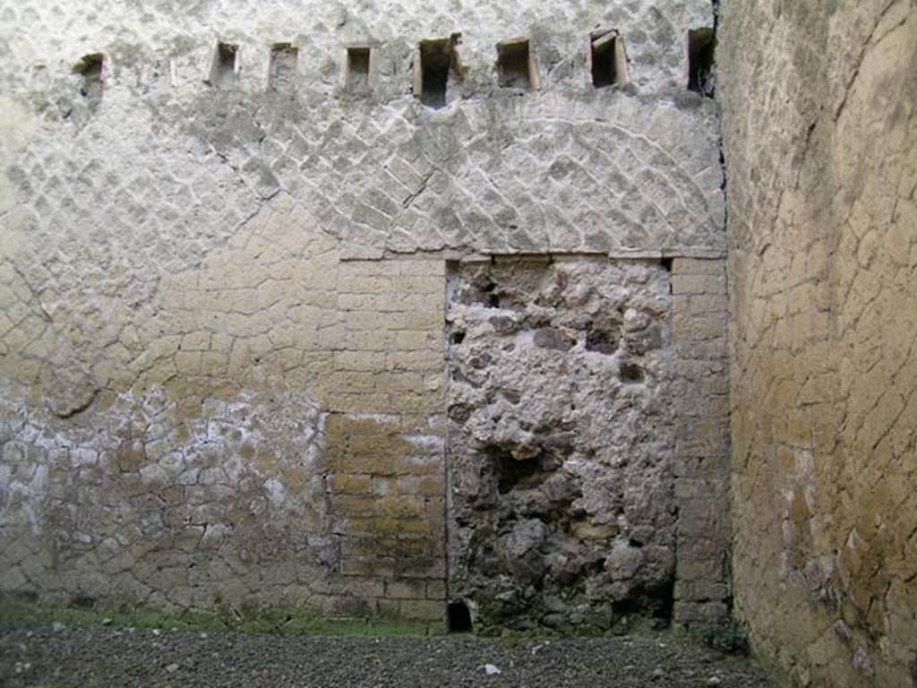 Ins Or II, 18, Herculaneum. May 2004. Rear room, south-east corner with bricked up doorway in east wall.
At one time this doorway would have led through to one of the rooms of the loggia of the Palaestra.
Photo courtesy of Nicolas Monteix.